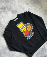 Bape x the Simpsons baby Milo behind Bart black sweatshirt